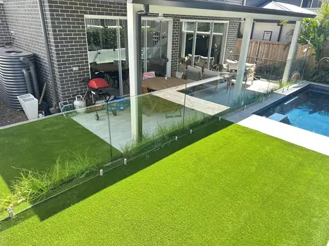 Artificial grass beside a pool in a Sydney backyard, installed by Turfland