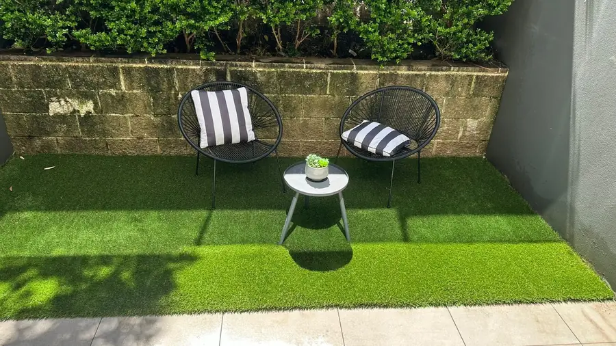 Outdoor chairs on a newly turfed courtyard