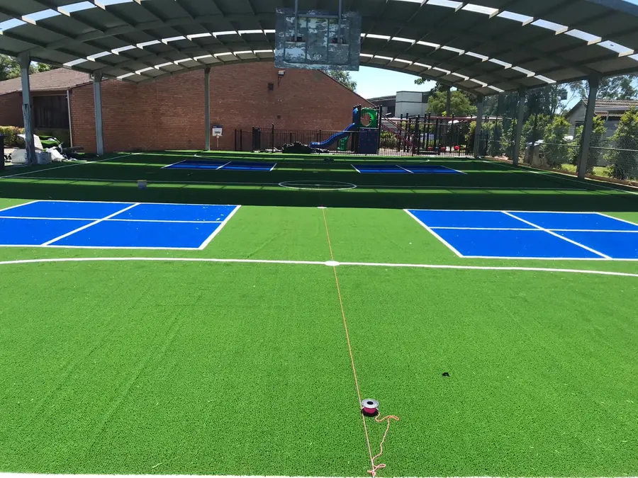 Covered multi-sport court with synthetic grass