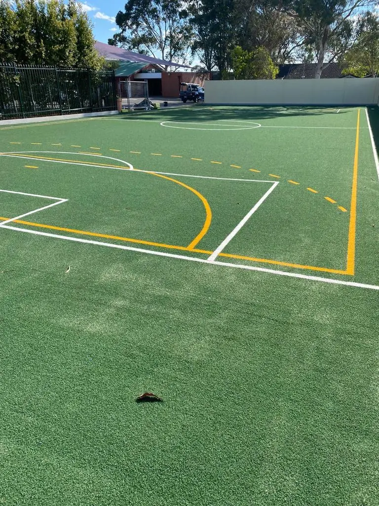 Green multi-sport court with line markings