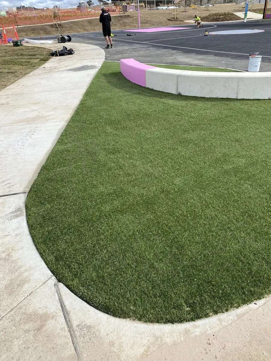 Curved synthetic grass garden beds at a school