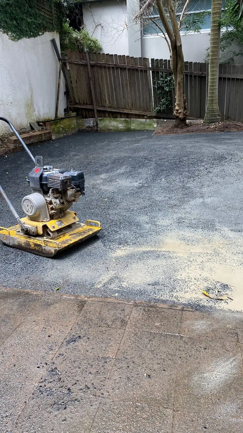 Compacting the crushed rock base before laying turf