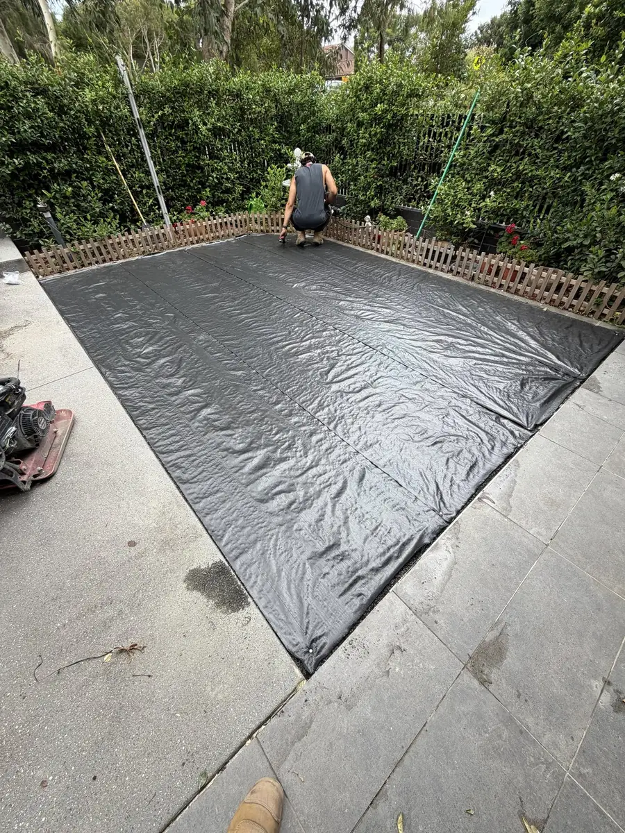 Weed membrane laid over the prepared base